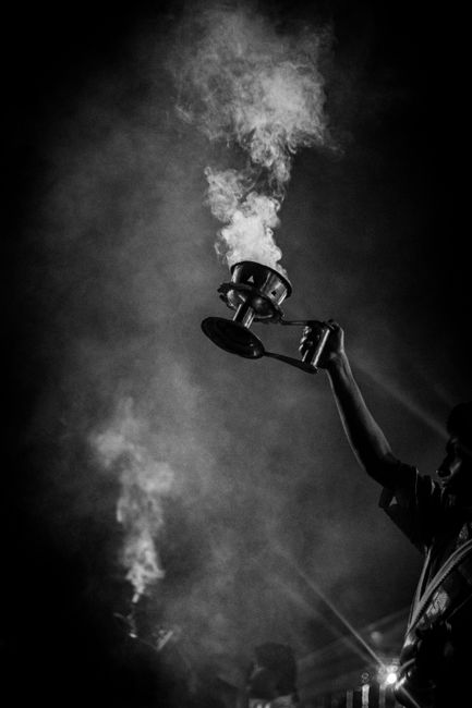 Black and white image capturing a traditional ritual with smoke and incense.