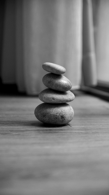 Black and white image of a stack of smooth stones evoking balance and tranquility.